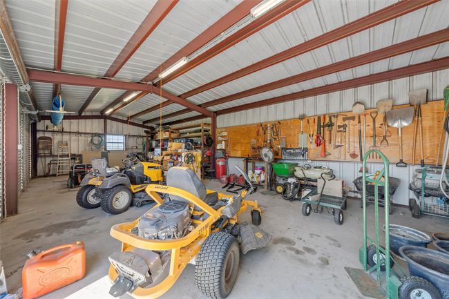 Garage with a workshop area and metal wall | Image 31
