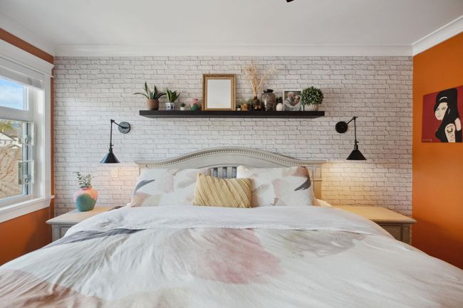 Bedroom featuring ornamental molding and brick wall | Image 16