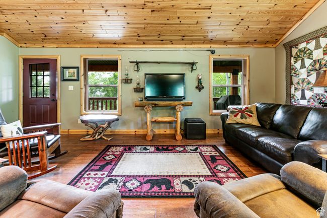 Living area featuring lofted ceiling, wood ceiling, plenty of natural light, and wood-type flooring | Image 13
