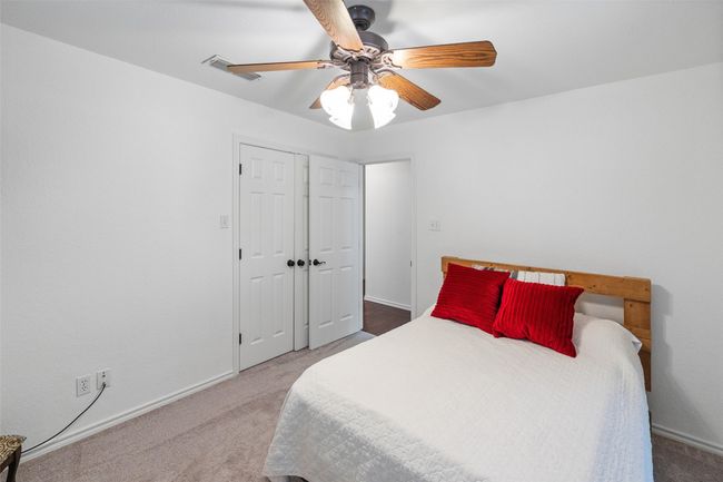 Carpeted bedroom featuring a closet, visible vents, baseboards, and a ceiling fan | Image 18