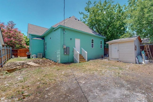 Rear view of property with a storage shed and central AC unit | Image 32