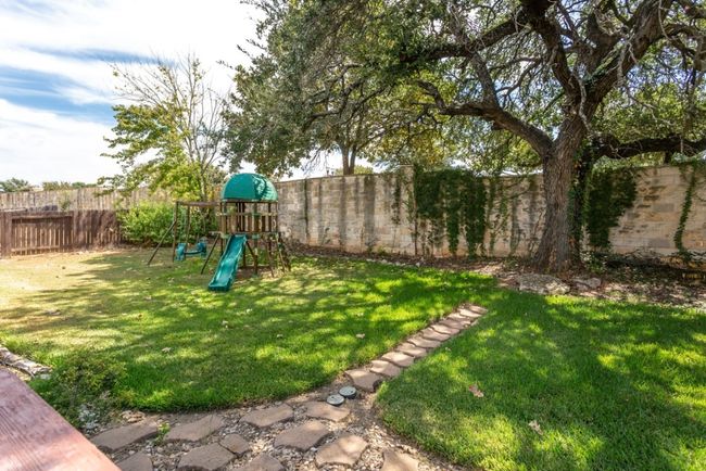 View of yard featuring a fenced backyard and a playground | Image 29