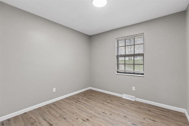 Unfurnished room featuring baseboards, a textured ceiling, visible vents, and light wood finished floors | Image 14
