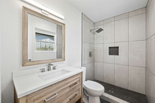 Full bathroom featuring a tile shower and vanity | Image 23
