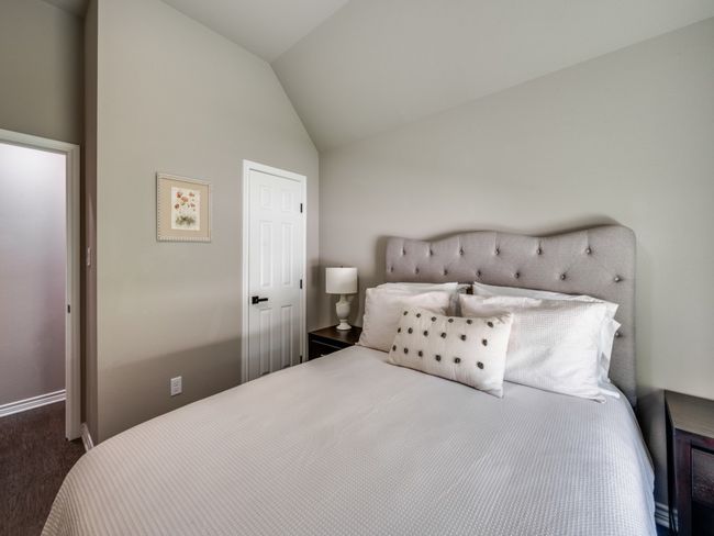 Bedroom with vaulted ceiling, carpet flooring, and baseboards | Image 16