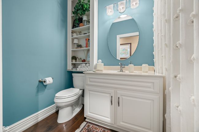 bathroom with toilet, wood finished floors, vanity, and baseboards | Image 39
