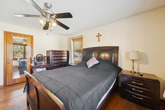 Bedroom featuring a ceiling fan and wood finished floors | Image 37