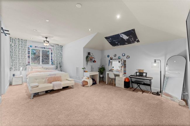 Upstairs, a large flex space provides versatile living options—ideal as a game room, media lounge, home office, or a potential fourth bedroom in the main house... | Image 34