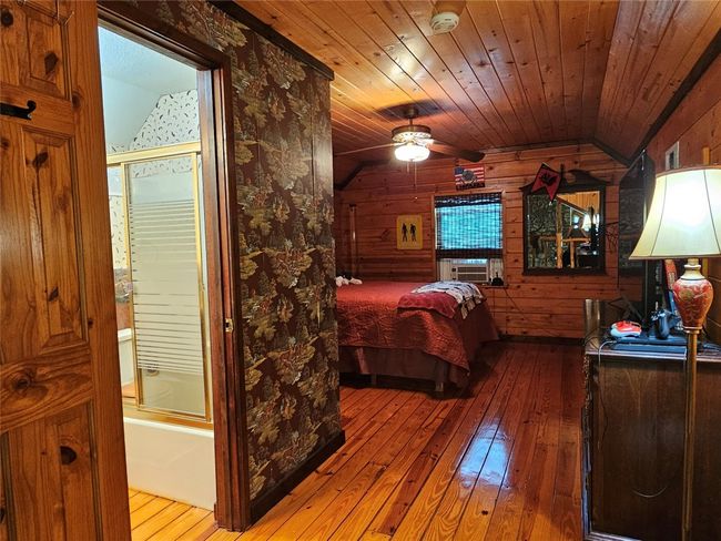 Upstairs Bedroom and Bathroom Suite with a Lofted Wood Ceiling | Image 28