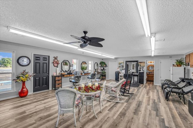 Dining space featuring baseboards, light wood-type flooring, and a textured ceiling | Image 7