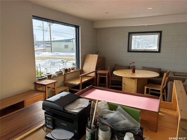 Living area with wood finished floors and concrete block wall | Image 11