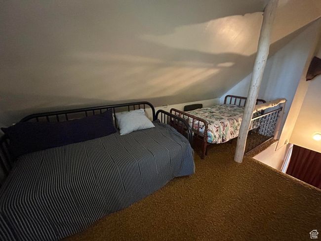 Carpeted bedroom featuring vaulted ceiling | Image 28
