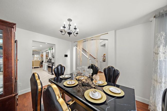 The dining room blends effortlessly with the rest of the home, offering a clear sightline to the kitchen and beyond. Whether hosting holiday meals or casual dinners, the open layout and updated finishes support any occasion with ease. | Image 13