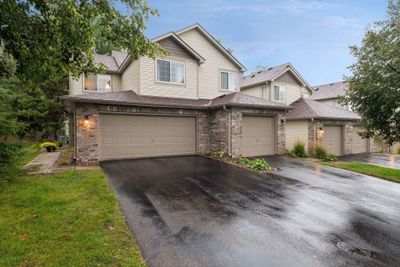 Stunning end-unit townhome nestled in a serene and peaceful neighborhood with 2 car attached garage and green space right out your patio door. | Image 1