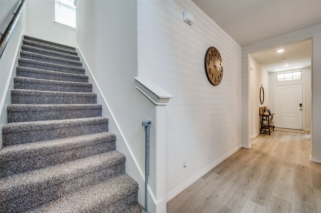 Stairway featuring baseboards, wood finished floors, and a wealth of natural light | Image 15