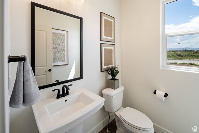 Half bath with toilet, a sink, and baseboards | Image 15