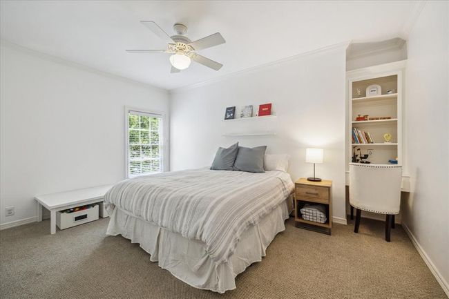 Fourth bedroom upstairs is a generous size, includes a built-in desk and a walk-in closet. Hardwood floors that match the rest of the second story are under the carpet!!! | Image 24
