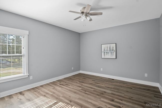 Unfurnished room featuring visible vents, ceiling fan, wood finished floors, and baseboards | Image 22