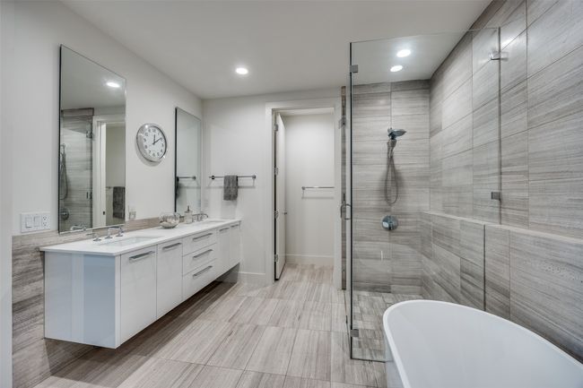 Bathroom with a soaking tub, a sink, and a stall shower | Image 23