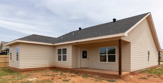 Rear view of property featuring a shingled roof, fence, and a patio | Image 4