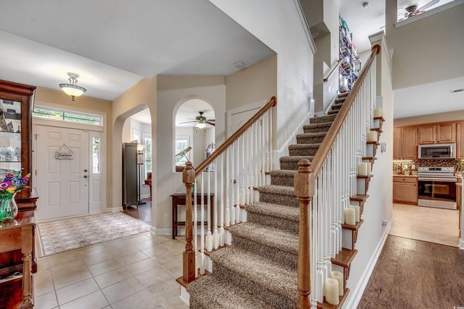 Entryway featuring arched walkways, stairway, LVP floors | Image 21