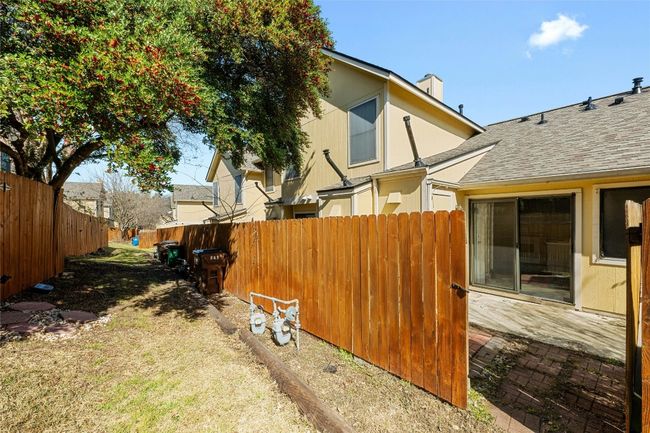 View of yard featuring fence and gate with easy access to greenbelt walking trails | Image 18