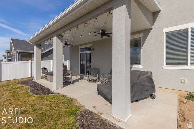 View of patio / terrace featuring a ceiling fan and fence | Image 44