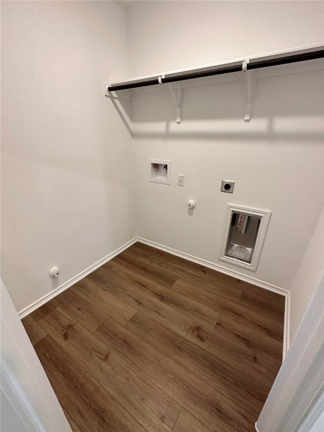 Laundry area featuring washer hookup, laundry area, hookup for a gas dryer, and dark wood-style flooring | Image 22