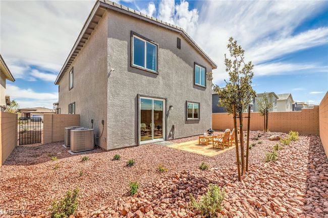 Photo is representational only; actual home finishes may vary. Rear view of property featuring stucco siding, a fenced backyard, and cooling unit | Image 41
