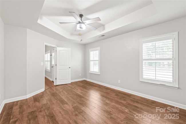 Another view of the primary bedroom without furniture. | Image 10