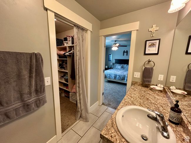 Ensuite bathroom featuring vanity and a closet | Image 16