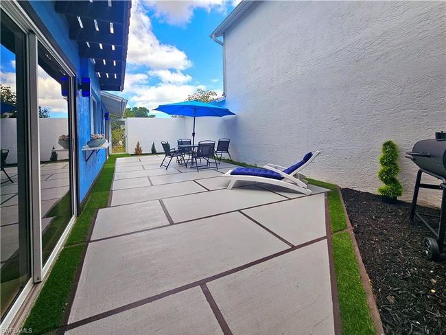 View of patio with area for grilling and outdoor dining area | Image 6