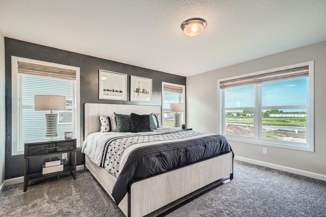 Photo is of the model. Extremely spacious and elegant, this private primary bedroom connects to a large en-suite bath providing a great oasis to relax in your own private space. | Image 12