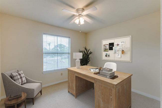 Home office featuring light carpet and a ceiling fan | Image 35
