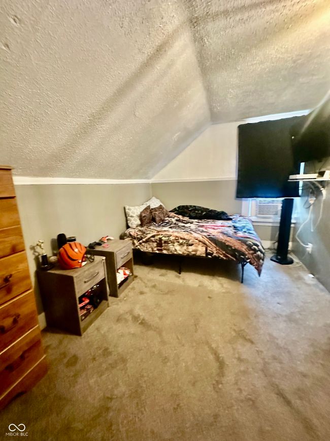 carpeted bedroom with a textured ceiling and vaulted ceiling | Image 29