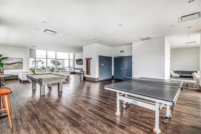 Playroom featuring billiards, wood finished floors, and expansive windows | Image 24