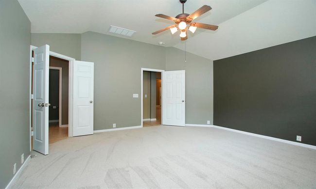 Primary suite sits to the back of the home and offers an abundance of space for all your furniture needs. En-suite bath to the left. | Image 19