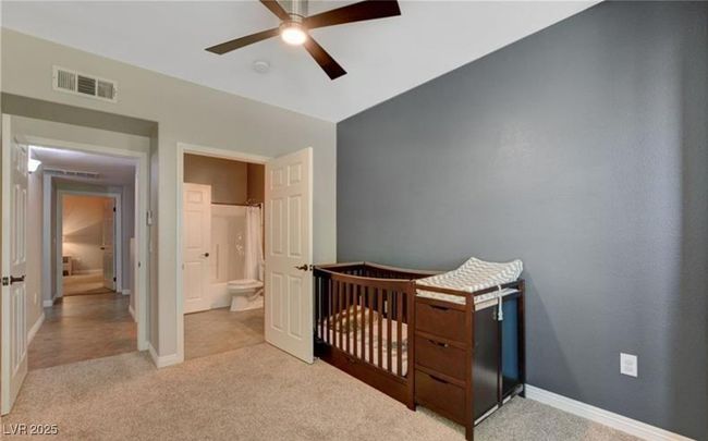 Bedroom with light colored carpet, visible vents, a ceiling fan, and baseboards | Image 17