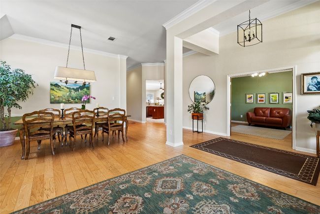 The seamless flow between the living and dining areas enhances the room's versatility, allowing for both casual gatherings and formal meals | Image 6