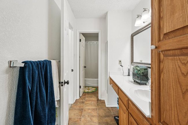 Full bathroom featuring vanity and a textured ceiling | Image 24