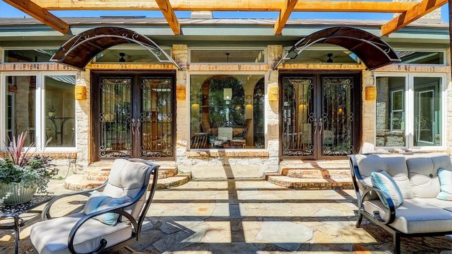 Doorway to patio/pool area through double French Iron Doors french doors | Image 40
