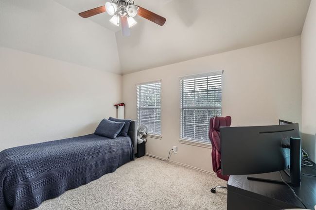 Bedroom with vaulted ceiling, carpet, and a ceiling fan | Image 27