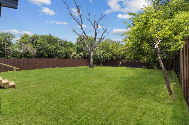 View of fenced backyard | Image 25