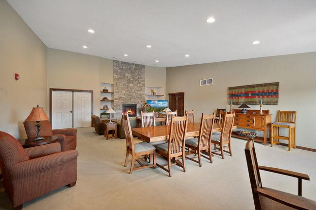 Humongous party room with a full kitchen, gas fire place, expansive dining room, and cozy couches is free to use | Image 22