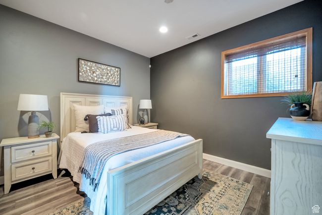 Bedroom with visible vents, baseboards, recessed lighting, and light wood-style floors | Image 28
