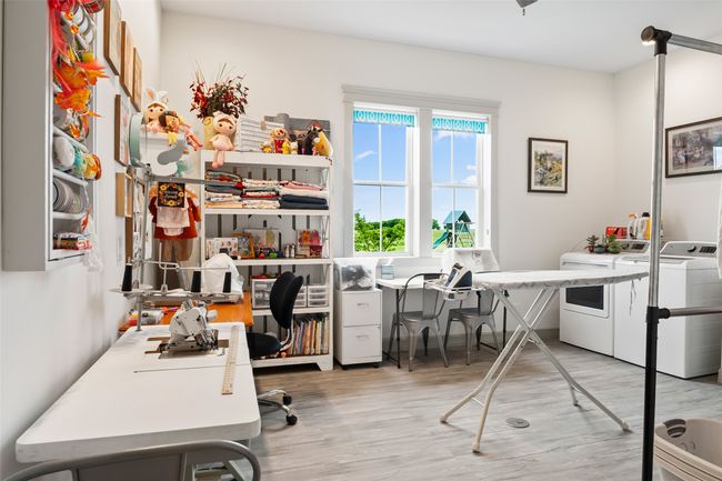 Office with light wood-style floors and washer and dryer | Image 24