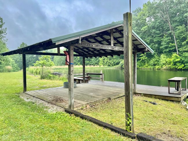 view of home's community featuring a lawn, a water view, and a boat dock | Image 36