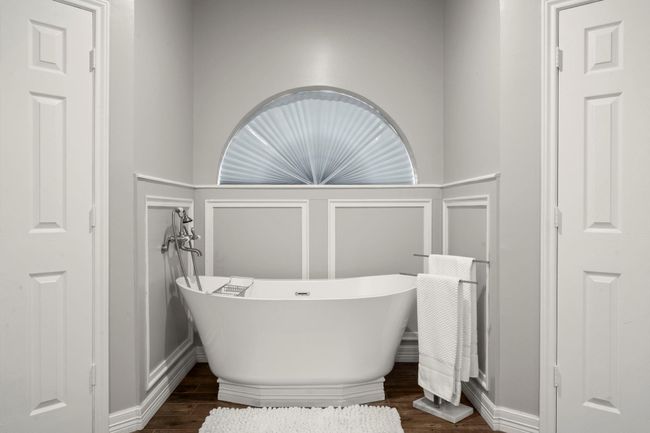 Get ready for this.... a fully remodeled primary bath with stand-alone soaking tub. Double closets on each side of the tub. | Image 21