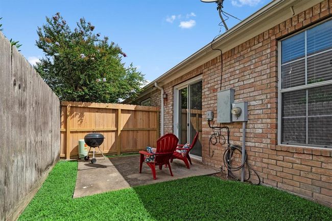 The backyard has a good amount of grass and patio space. | Image 27