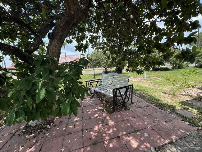 View of community featuring a lawn and a patio area | Image 4